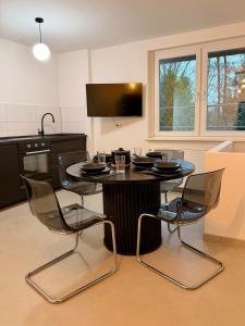 a kitchen with a black table and chairs in a room at Modern, bright apartment for individuals & groups in Remscheid