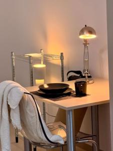a table with a lamp and a plate on it at Modern, bright apartment for individuals & groups in Remscheid +11 photos