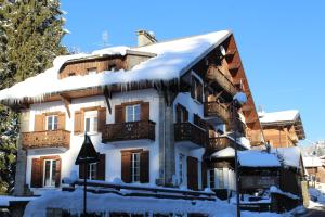 a house with snow on the roof at Le Chalet d'Antoine - Centre de Megève in Megève