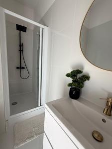 a white bathroom with a sink and a mirror at Apartament SLEEP&GO Ostrowiec Świętokrzyski in Ostrowiec Świętokrzyski +16 photos