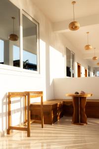 a dining room with a wooden table and mirrors at OMNYA Nungwi Boutique Hotel in Nungwi