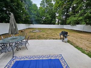 a patio with a grill and a table and a grill at Less is Moore in Thompsonville