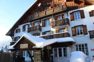 a building with snow on the front of it at Le Chalet d'Antoine - Centre de Megève in Megève