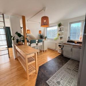 a kitchen and dining room with a wooden table and a dining room at Gemütliche Galeriewohnung im Grünen in Trappenkamp +25 photos