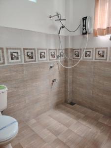a bathroom with a shower with a toilet in it at Charlotte Inn in Kandy +66 photos
