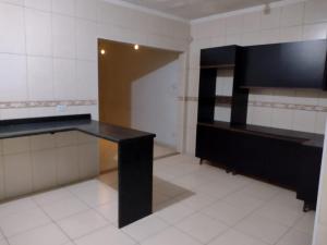 a room with a black table and a mirror at Mar e sol in Itanhaém