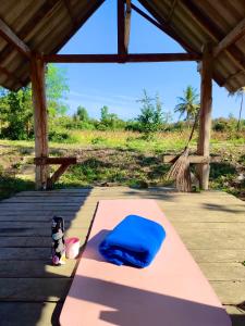 a pink yoga mat with a blue pillow on it at RSP Hostel รักษ์สุพรโฮสเทล in Ban Hua Thung