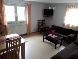 a living room with a couch and a table at Ferienwohnung Neifer in Bad Überkingen