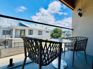 a balcony with a table and chairs on a balcony at West14 Tamarin Bay,Studio in Tamarin