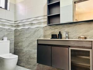 a bathroom with a toilet and a sink at West14 Tamarin Bay,Studio in Tamarin
