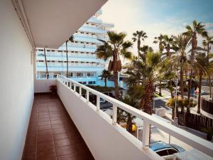 a balcony with a view of a hotel and palm trees at Valparaíso Apartments Flamingo in San Bartolomé