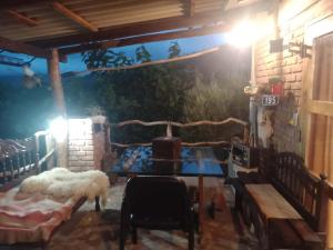 a room with a table and chairs and a wall at Cabaña Renacer in Samaipata