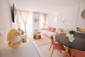 a living room with a couch and a table at Confort & Charme in Grignols