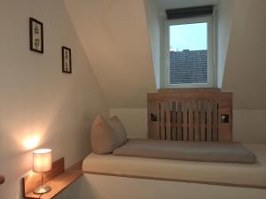 a bed in a room with a window at Südhotel in Paderborn
