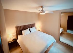 a bedroom with a white bed and a mirror at Valparaíso Apartments Flamingo in San Bartolomé +45 photos