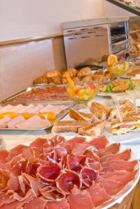 a table topped with lots of different types of food at Ayre Hotel Alfonso II in Oviedo