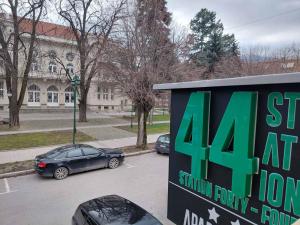 a sign in a parking lot in front of a building at Station 44 Apartments in Bitola