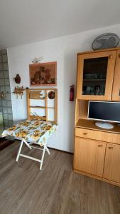 a room with a desk with a tv and a chair at Casa Vacanze S&B in Viola