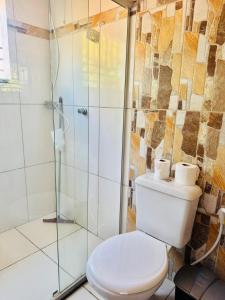 a bathroom with a toilet and a shower at Casa Adriê in Itacaré +21 photos