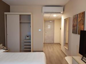 a room with a bed and a hallway with a door at Hotel Des Alpes in Rosta +94 photos