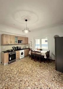 a living room with a kitchen and a dining room at Mytilene Heritage Loft 3A2 in Mytilene