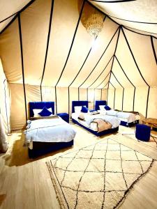 a room with two beds in a tent at Nour Desert Luxury Camp in Merzouga +119 photos