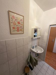 a bathroom with a sink and a mirror at Apartment Kompakt Gottschalk 5,0 in Kassel