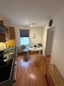 a kitchen with a table and a small table in a room at Apartment Kompakt Gottschalk 5,0 in Kassel