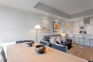 a living room with a table and a couch at Luxury II in Madrid