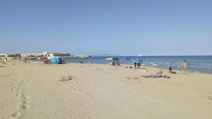 a group of people on a beach near the water at Buonavacanza in Erice