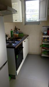 a small kitchen with a stove and a sink at Buonavacanza in Erice