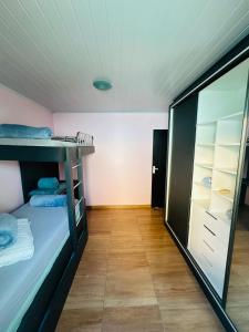 a room with a bunk bed and a closet at casapraia penha sc in Penha