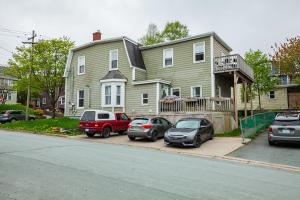 a house with three cars parked in front of it at Little Banook B&B in Halifax