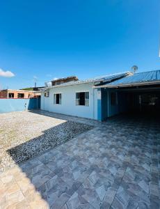 a house with a stone patio in front of it at casapraia penha sc in Penha