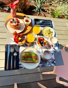 a table with plates of food on top of it at Maison Mahana in Bonifacio