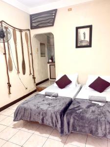a bedroom with two beds in a room at Placido's Vacation Home in Puerto Galera