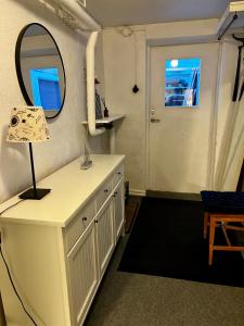 a room with a mirror and a dresser with a lamp at Nordic Quiet Stay in Falun +107 photos