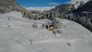 a house in the middle of a snow covered mountain at Moomooland in Bergün +15 photos