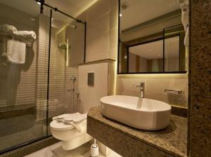 a bathroom with a sink and a toilet at Gold's Pyramids Hotel in Cairo +80 photos