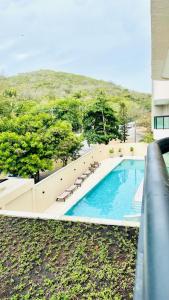 an overhead view of a swimming pool with lounge chairs at Prainha Sand Beach Arraial do Cabo in Arraial do Cabo