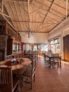a dining room with a large wooden table and chairs at Pousada Neuza Barbosa in Tiradentes