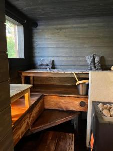 a room with a wooden bench in a cabin at Nordic Experience Nuuksio Sauna in Nuuksio