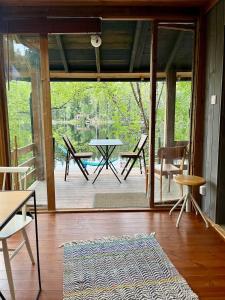 a screened in porch with a table and chairs at Nordic Experience Nuuksio Sauna in Nuuksio +23 photos
