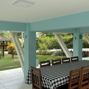 a black and white checkered table and chairs on a patio at Casa Jauá ParaisodePainho in Camaçari