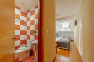 a bathroom with a toilet and a bed in a room at DownTown Guest House in Lisbon +189 photos