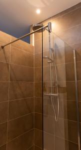 a shower with a glass door in a bathroom at Effets Personnels in Orange +113 photos