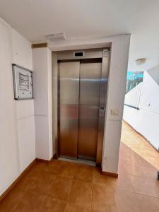 a elevator in a building with a metal door at Apartamento Morro de Gos Ref067 in Oropesa del Mar +17 photos