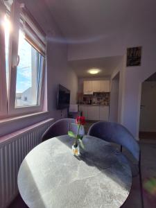 a table with a vase with a flower on it at Villa Vino & Grad in Zagreb