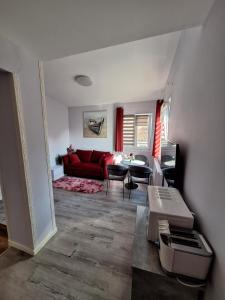 a living room with a red couch and a table at Villa Vino & Grad in Zagreb