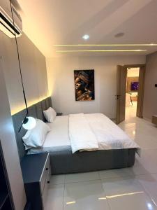 a bedroom with a large bed in a room at Cosmos in Lagos
